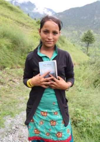 Leah holds a Nepali Bible.