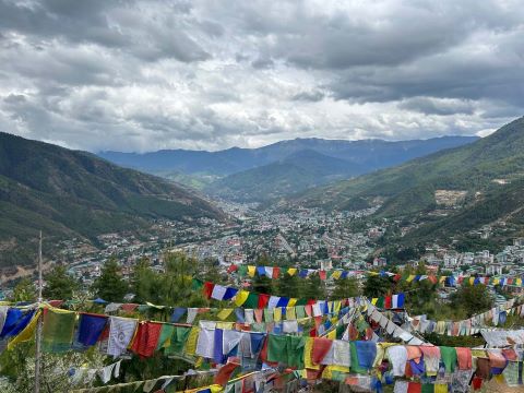 Buddhist prayer flags fly over a city in Bhutan.