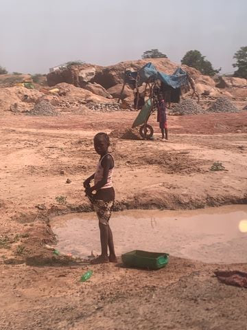 Children in Burkina Faso often work with their widowed mothers crushing rocks.