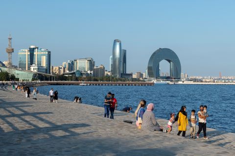People walk along the Caspian Sea in Baku.