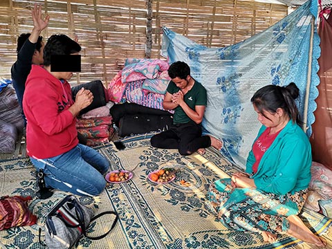 Gate (center) and his wife (right) have been barred from two villages for their Christian faith. Yet, they remain firm in their faith in Jesus Christ.