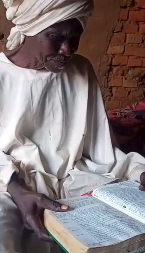 Mustafa reading from his son's Bible.