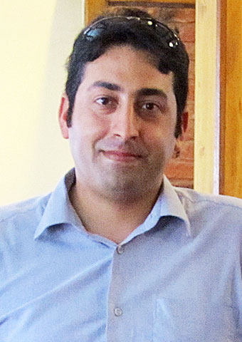 Pastor Emre stands in his church.