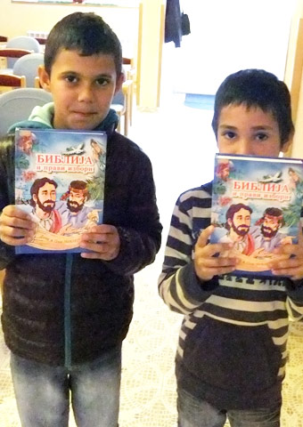 These children stand in their Sunday classroom with their new copies of the Right Choice Bible.