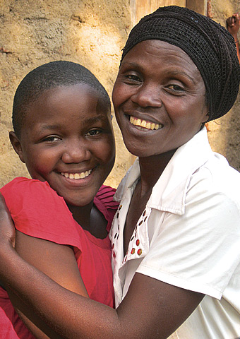 Susan, who survived persecution from her own father in Uganda, is shown hugging her guardian, Dedra