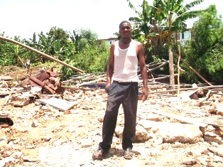 Pastor Esmir stands in the ruins of his home and church shortly after Cuban authorities destroyed the home.