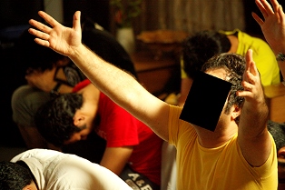 A Christian man who lives in Iran cries out to God during a time of prayer and worship
