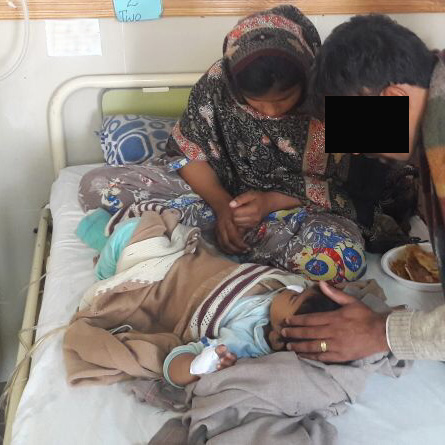A VOM partner prays with one of the bombing victims.