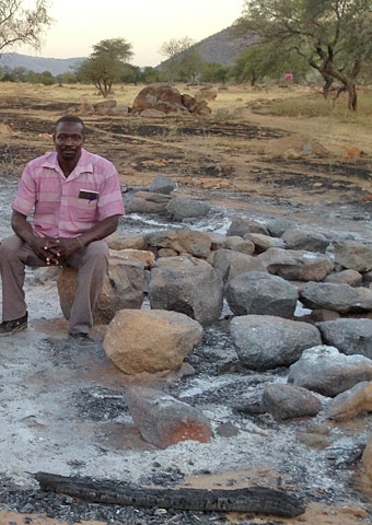 A pastor sits among the ruins of a church that was bombed in the Nuba Mountains, Sudan.