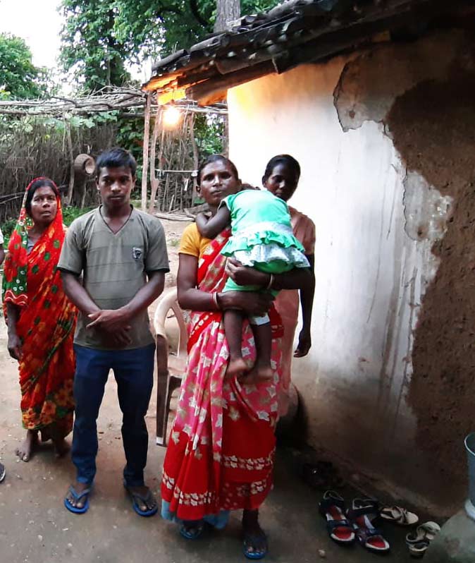 Naadir (center with the green shirt) and his daughter (held by a neighbor) watched family members murder his wife because of her faith.