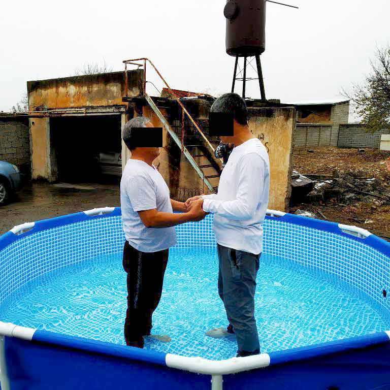 A Central Asian believer is baptized in a pool.