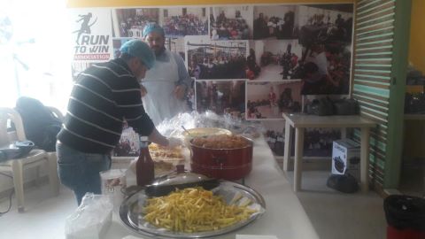 Workers help with meal distribution at an outreach center.