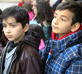 Two Iraqi children recently received gifts for refugee children living with their families in Jordan.