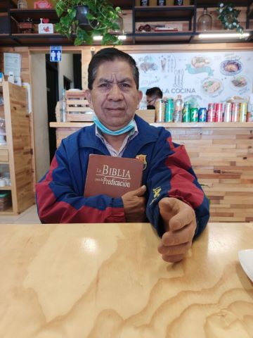 Pastor Manuel with a new Bible and arm