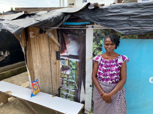 Flora outside her home