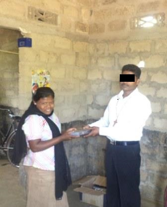 A woman happily accepts a Bible given to her by a pastor in Sri Lanka.