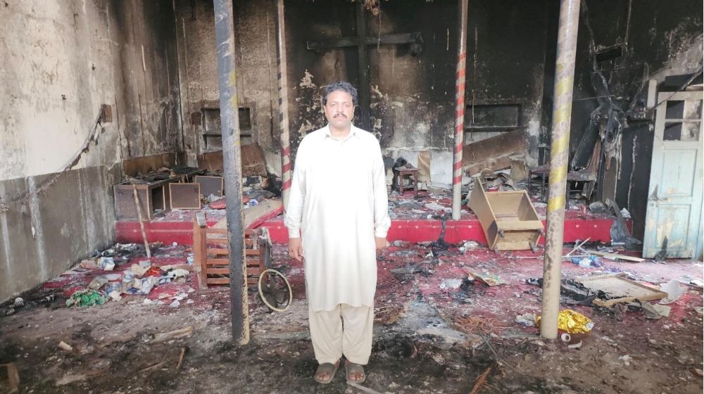 A Pakastani Christian stands in the remains of one of the churches destroyed during the Jaranwala Islamic riots.