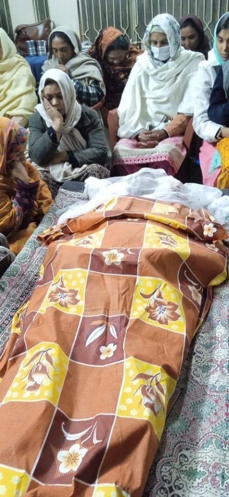 Pastor Malik Salamt's family and friends mourn near his body.