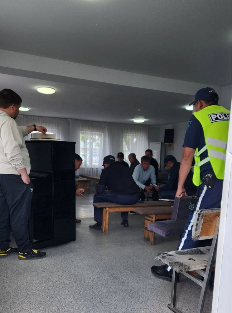 Kazakh police electronically file charges against church members inside a church in Semey, Kazakhstan.