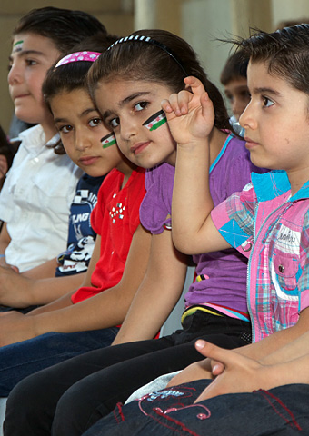 A group of Syrian refugee children who are listening to Jordanian Christians share Bible stories.