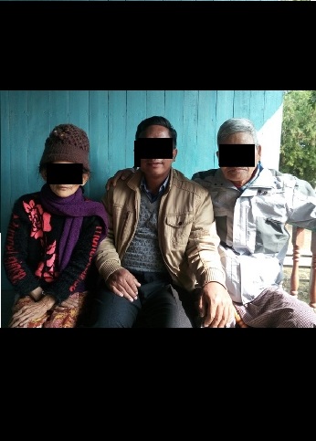 A Christian worker sits between Pastor "Kam" and his wife.