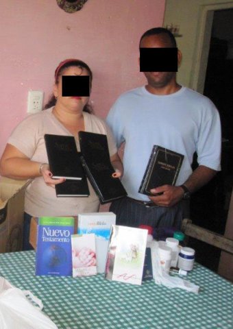 Christians in Cuba display some of the Bibles and Christian books they were given.