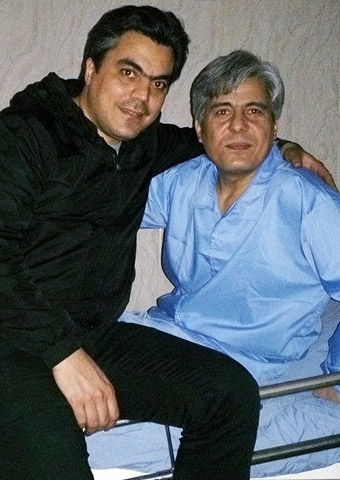 Pastor Behnam Irani visits with his younger brother. Handcuffed to the bed as he recovers from surgery, Pastor Irani recently had his Bible seized by secret police.