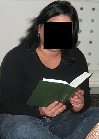 A house church member participates in worship where both unregistered activities and Christian literature are considered illegal.